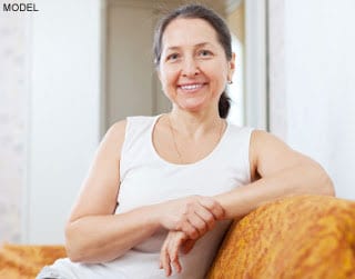 Smiling ordinary mature woman in home interior