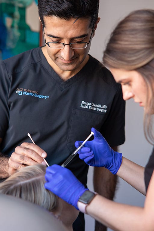 Dr. Chaboki and assistant performing surgery on patient